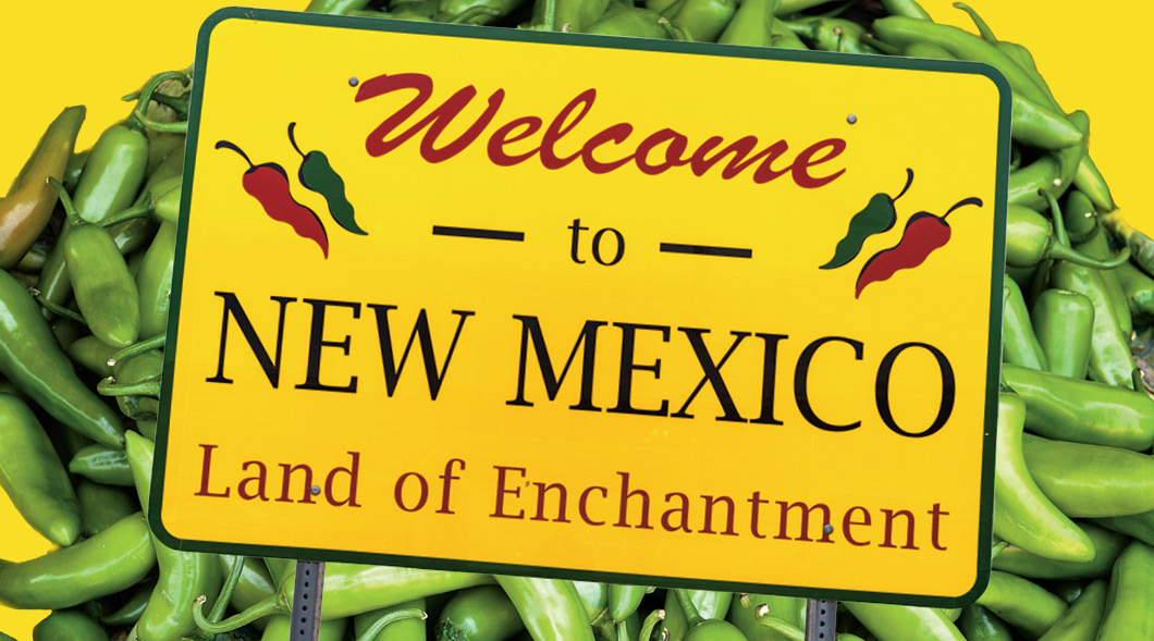 Sign with text, "Welcome to New Mexico, Land of Enchanment" and hot peppers in background
