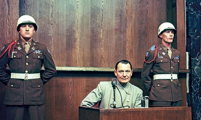 Two soldiers standing next to a person on trial
