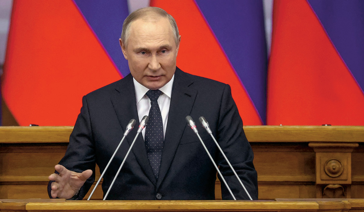 Russian President Vladimir Putin giving a speech in front of a podium