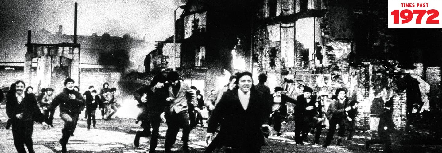 Black & white photo of people running away from a burning building. Text reads, "Times Past 1972"