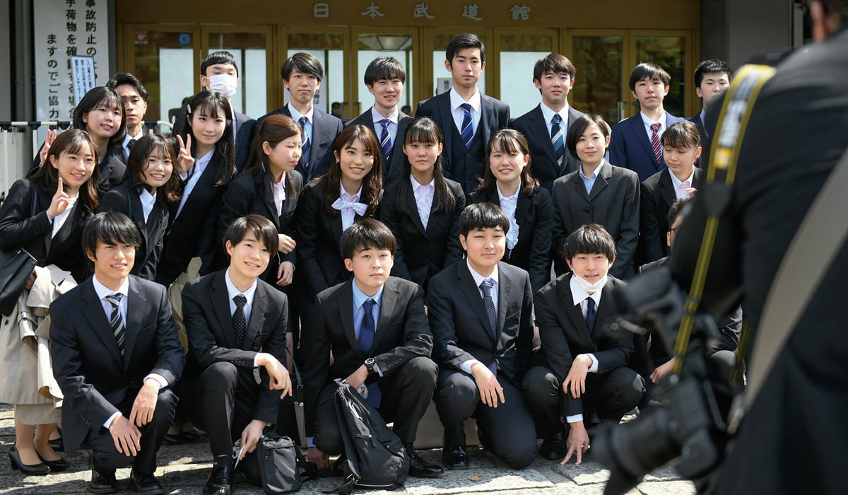 Photo of Japanese students wearing uniforms and posing for photo