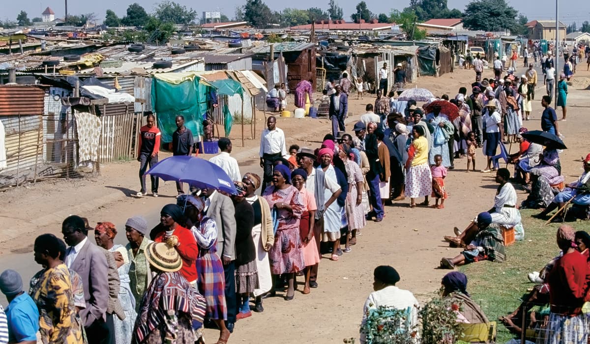 Photo of people from poverty-stricken homes waiting in a long line