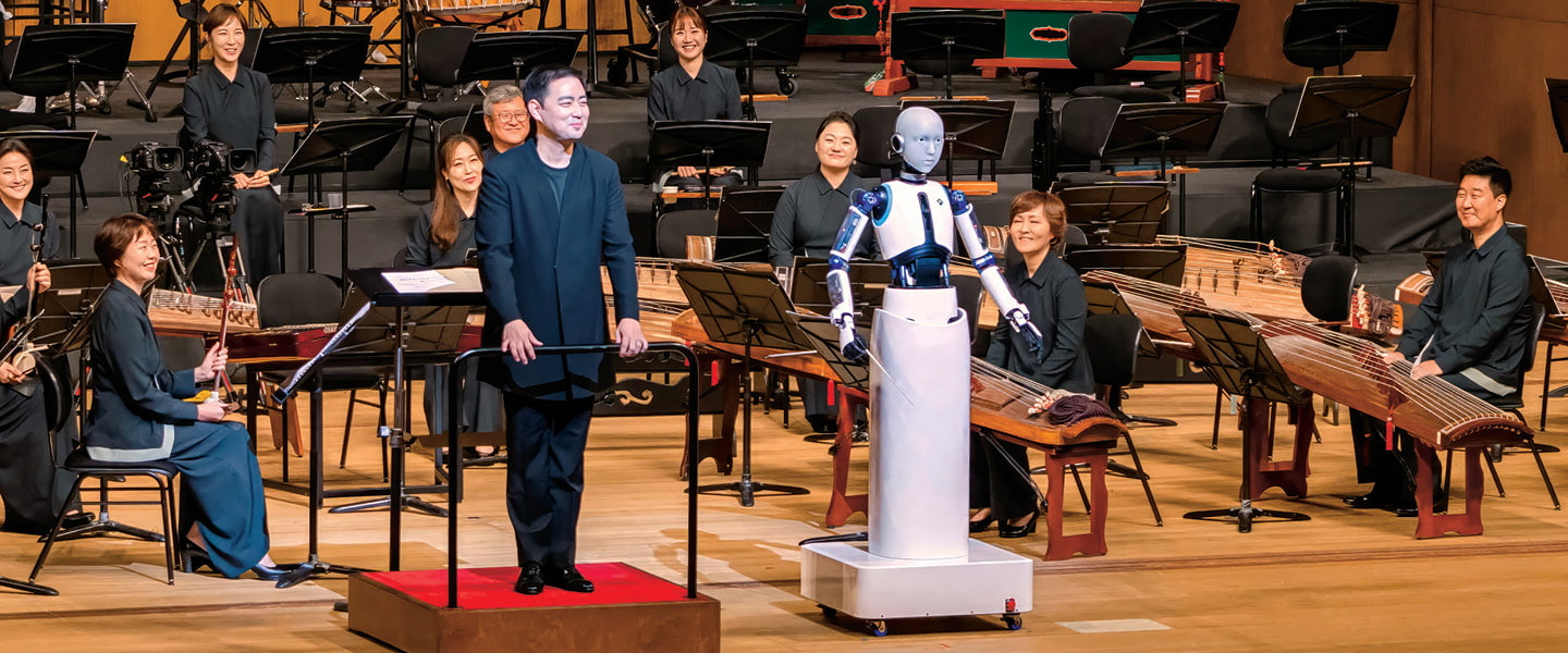 Image of musicians and a maestro performing on stage with a robot
