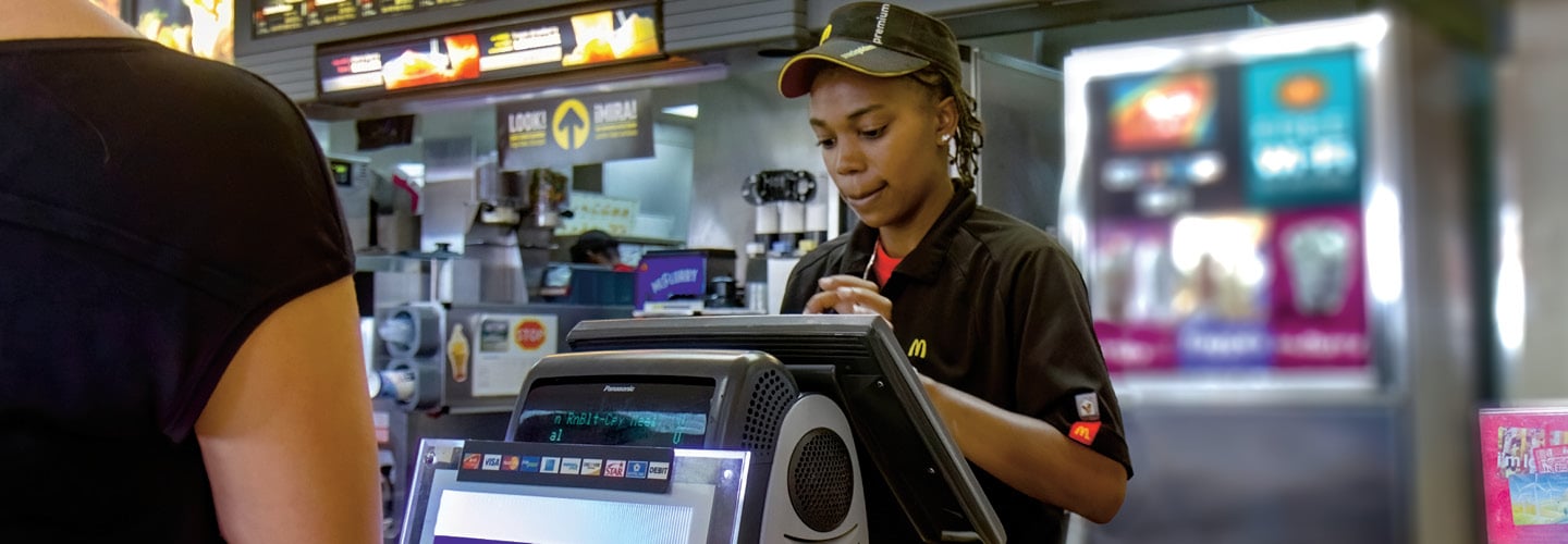 Photo of a cashier working at a fast food restaurant