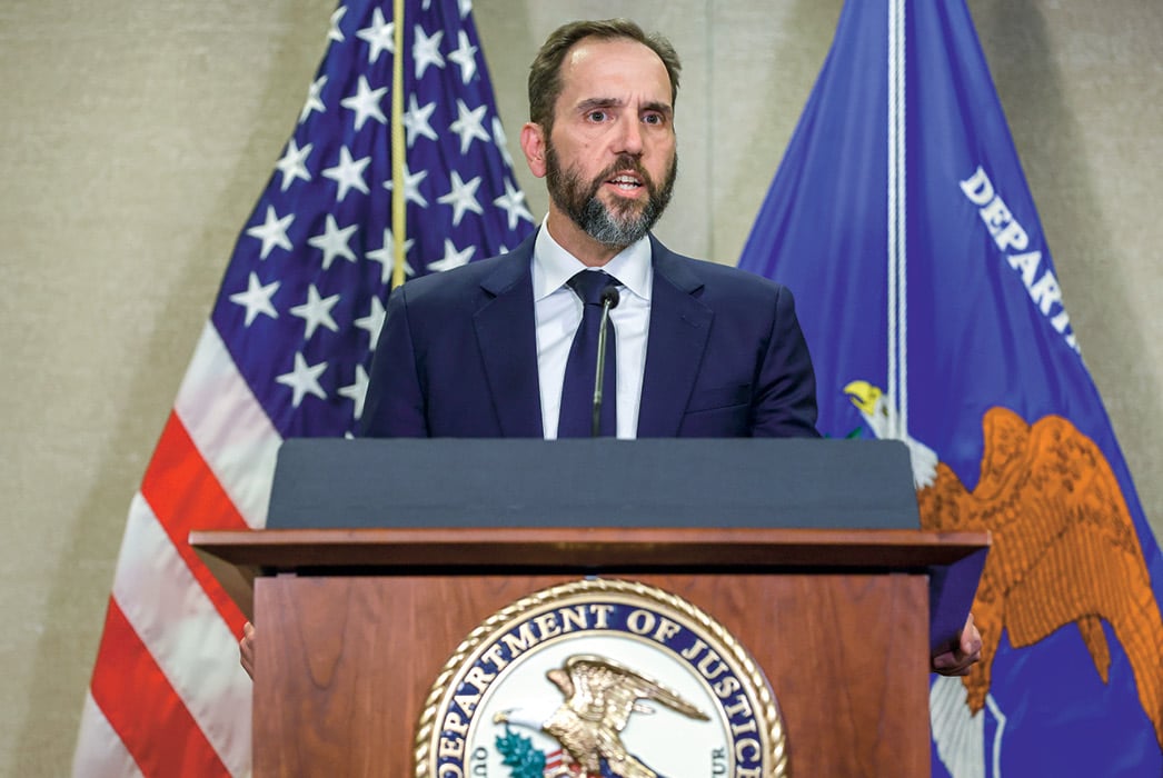 Image of an official speaking in front of a national podium