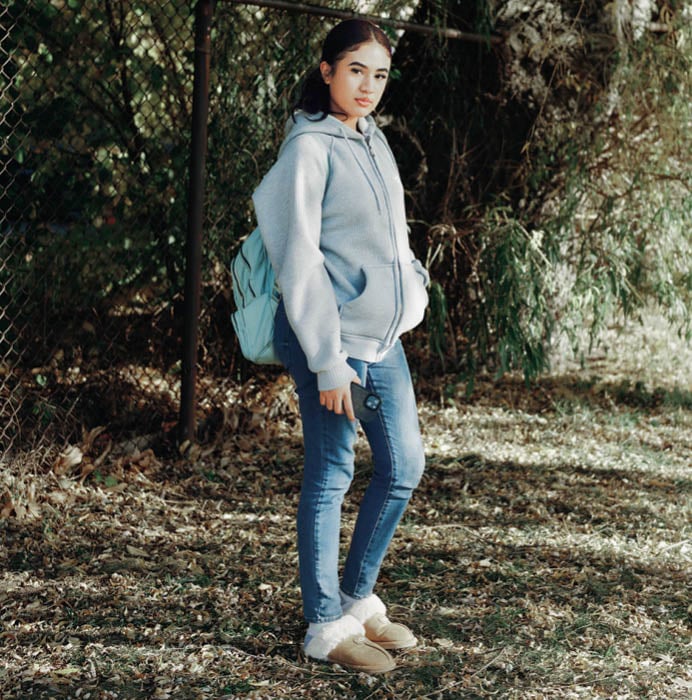Image of student posing with their backpack
