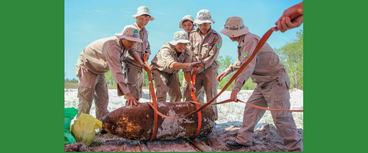 Photo of small group of soldiers working to destroy a bomb