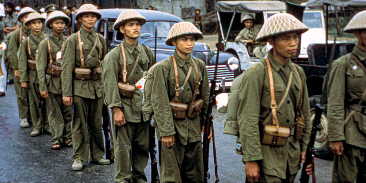 Colorized photo of a line of Vietnam soldiers
