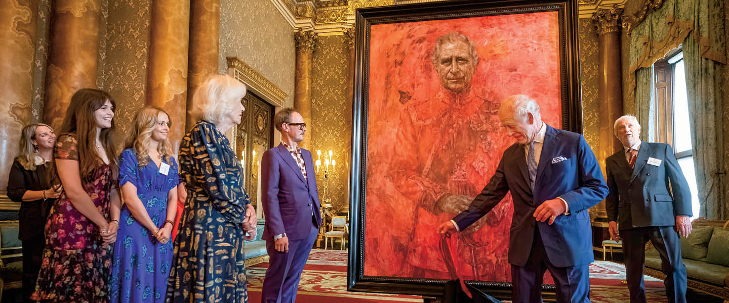 Image of King Charles III standing in front of a portrait of himself