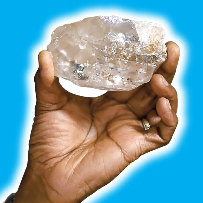 a hand holding an enormous diamond