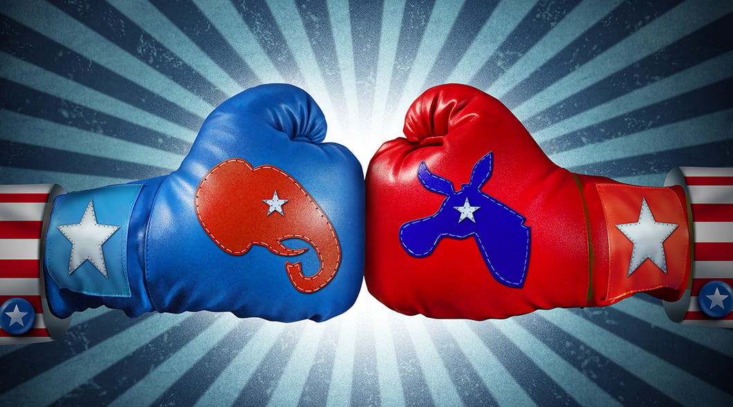 Two boxing gloves meet fist to fist, one blue with a Republican elephant, one red with a Democratic donkey