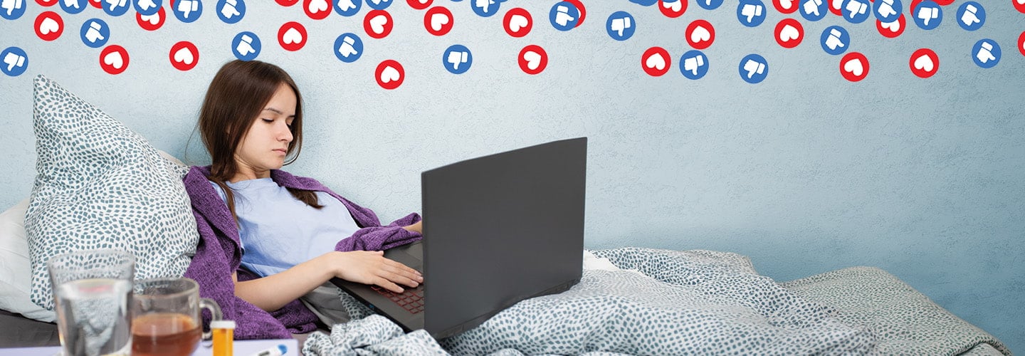 Composite image of a girl lying in bed typing on a laptop as heart & thumbs-down icons fill the wall